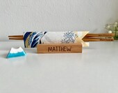 Japanese-style engraved chopsticks set with a custom wooden stand engraved with your name, a Fuji Mountain ceramic rest, and wrapped in traditional Ukiyoe Chiogami origami paper thumbnail 1