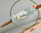 Custom engraved chopsticks with a personalized wooden stand and wire circle, wrapped in traditional pattern origami. A perfect gift set for Asian cuisine lovers, combining elegance and functionality. Ideal for sushi, ramen, or everyday dining, this s thumbnail 2