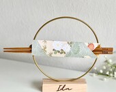 Custom engraved chopsticks with a personalized wooden stand and wire circle, wrapped in traditional pattern origami. A perfect gift set for Asian cuisine lovers, combining elegance and functionality. Ideal for sushi, ramen, or everyday dining, this s thumbnail 1