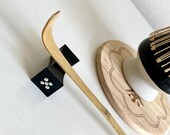 Personalized matcha tea set featuring engraved bamboo whisk and scoop with rhinestones, ceramic black whisk holder, scoop rest, and double-sided engraved wooden coaster. One side of the coaster shows Japanese matcha characters, the other features mat thumbnail 6